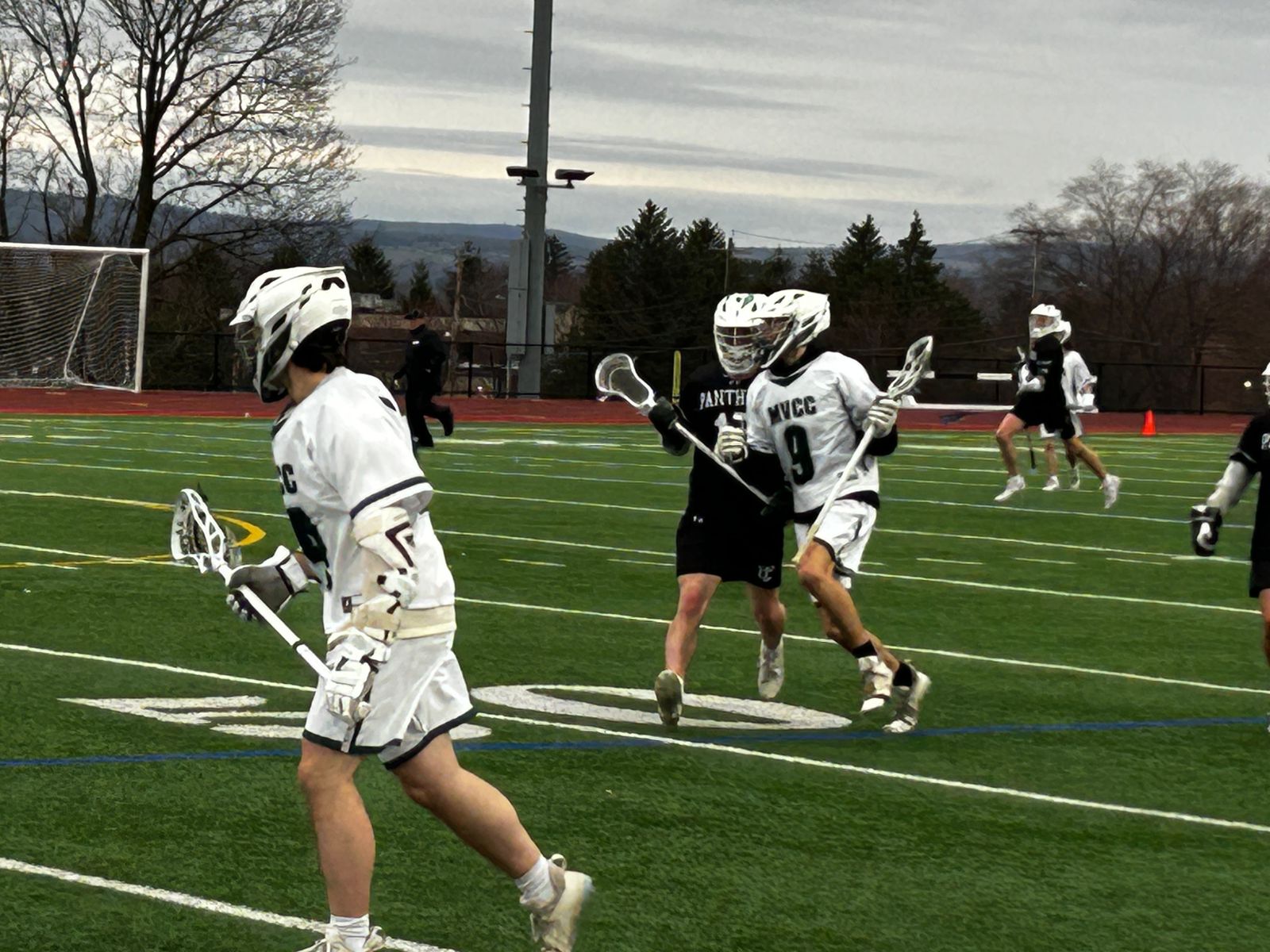 Hawks player drives past opponent.