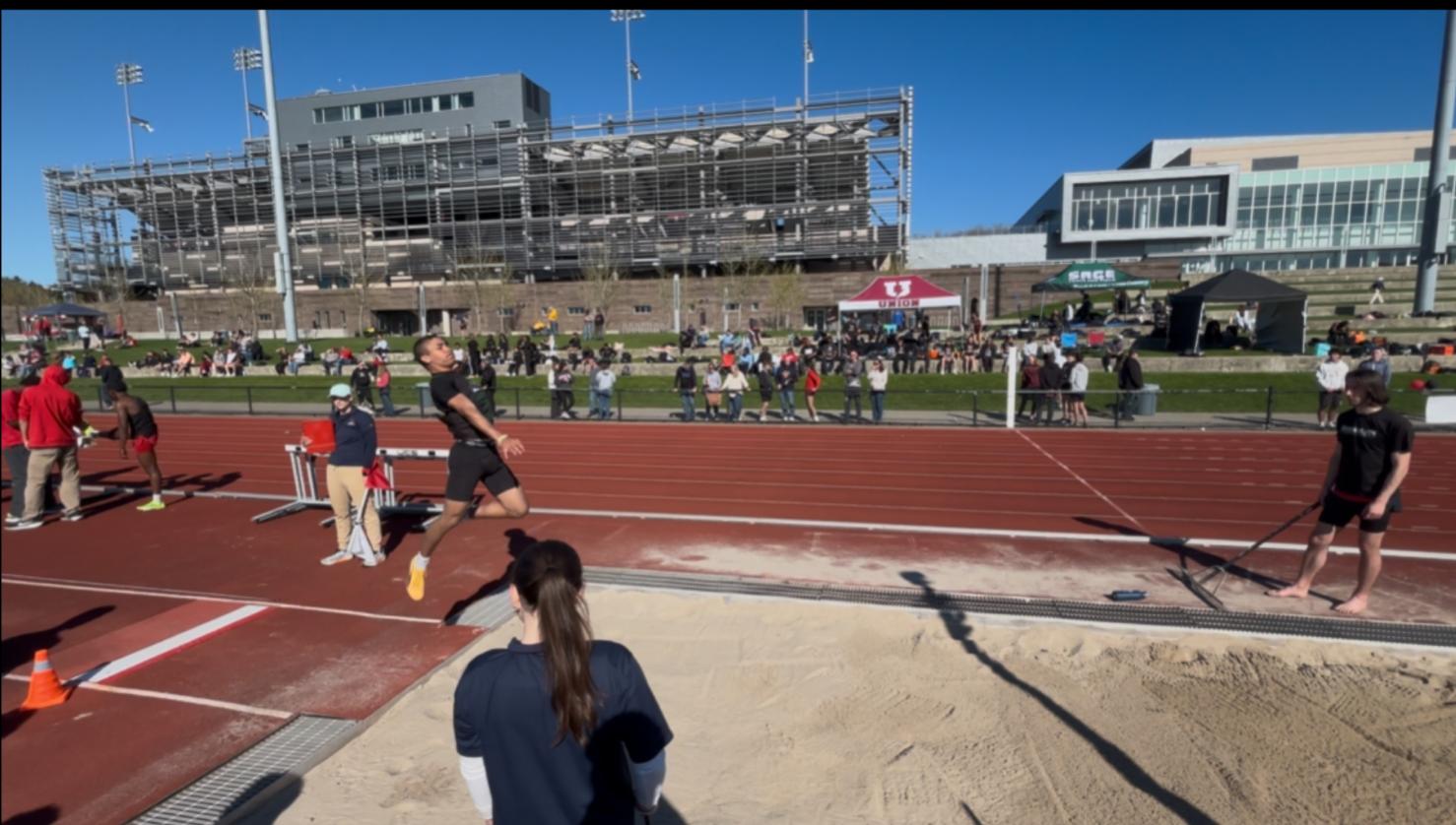 Hawk athlete performing the long jump.
