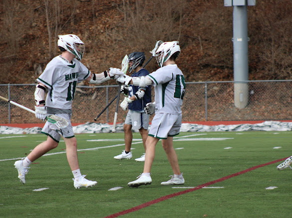 Hawks players celebrate after scoring a goal.